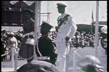 Princess Elizabeth and the Duke of Edinburgh receive the Royal salute by the RAF Guard of Honour and stand for the playing of the National Anthem by the RAF Band at Eastleigh Airport, Nairobi on 1st February 1952.