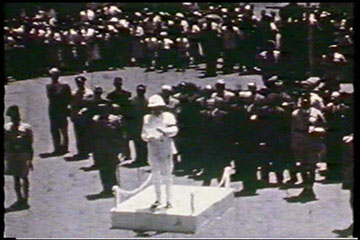 On 9th February 1952, in Waterloo Lamp Square, Nakuru, the Acting Provincial Commissioner for the Rift Valley Province, Mr. R.D.F. Ryland, reads the proclamation of the accession of Her Majesty Queen Elizabeth II.